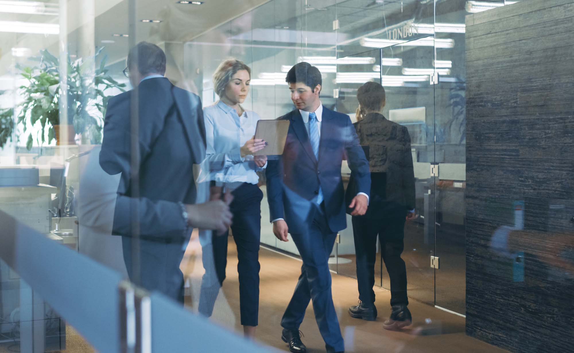 A lawyer walking with his secretary at his law firm